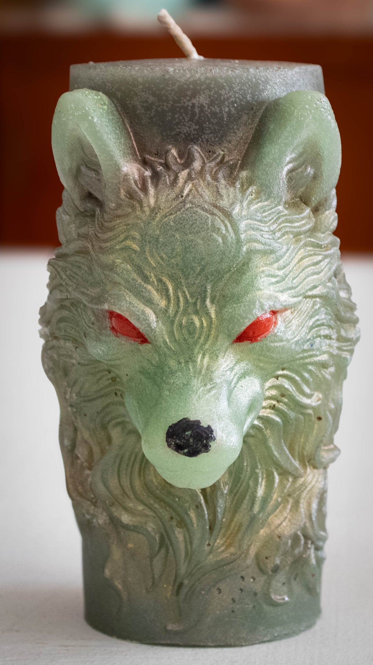 Embossed Wolf Head Pillar Candle — Sage Green with Crimson Eyes